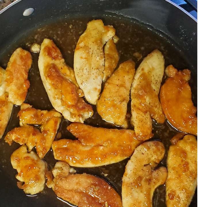 Twinethyme One pan honey garlic chicken recipe chicken browned in sauce pan with honey garlic sauce on it