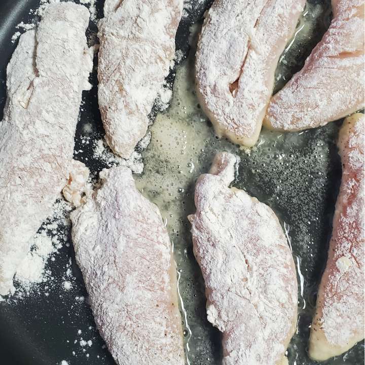 twinethyme pinterest pin showing one pan honey garlic chicken recipe chicken in pan frying